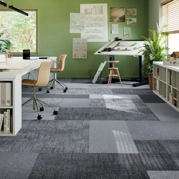 Creative studio with green walls and grey checkered carpet tiles.