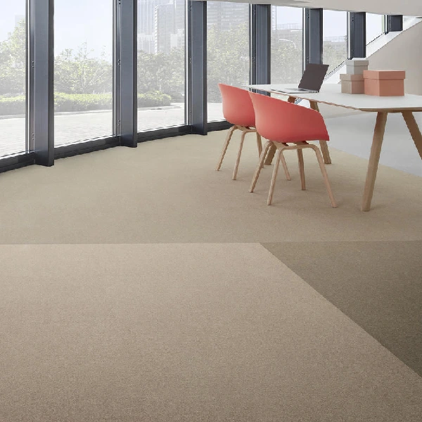 Textured moss-green area rug under a round black table.