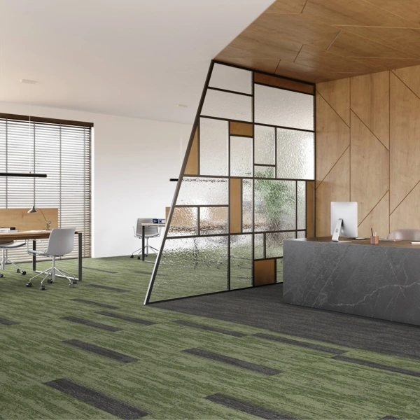 green and grey textured commercial carpet tiles in a office space.