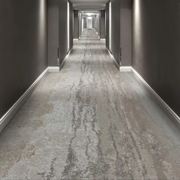 multi-tonal grey carpet in a long, modern hallway
